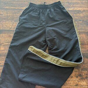 Black track pants with a camo green and white stripe down the sides